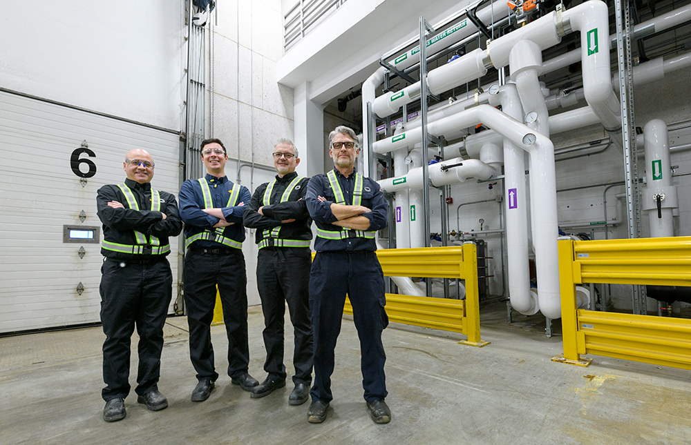 Team in front of geoexchange pipes